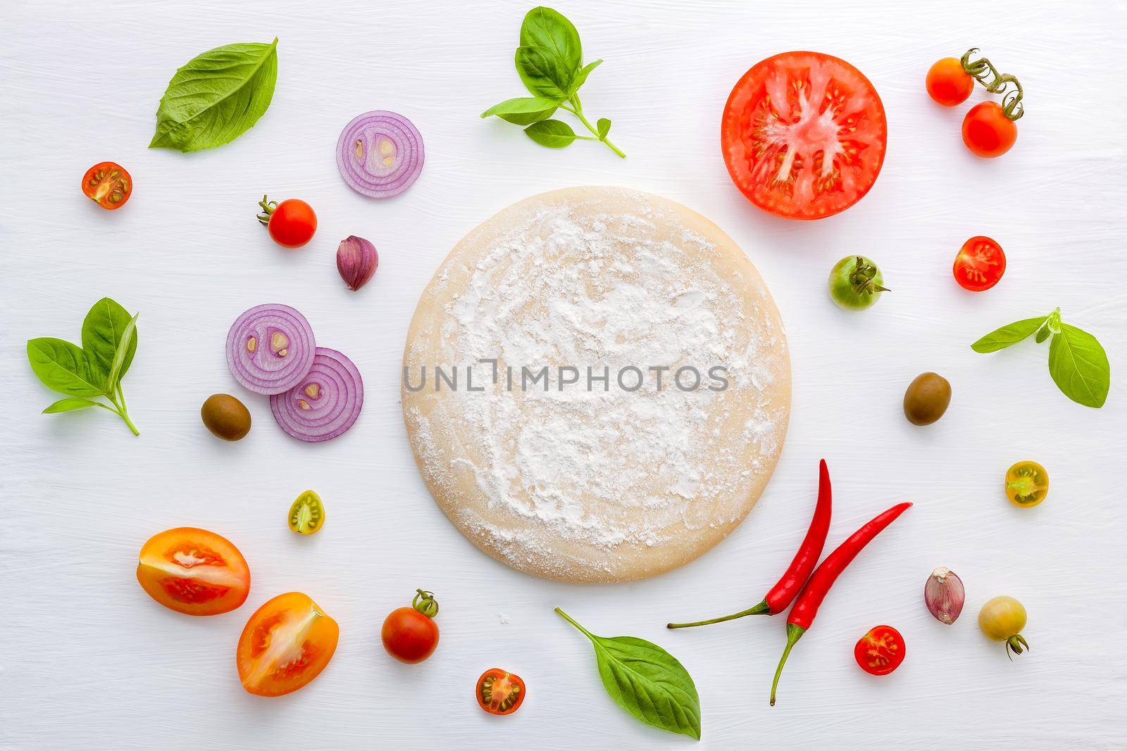 The ingredients for homemade pizza on white wooden background. by kerdkanno