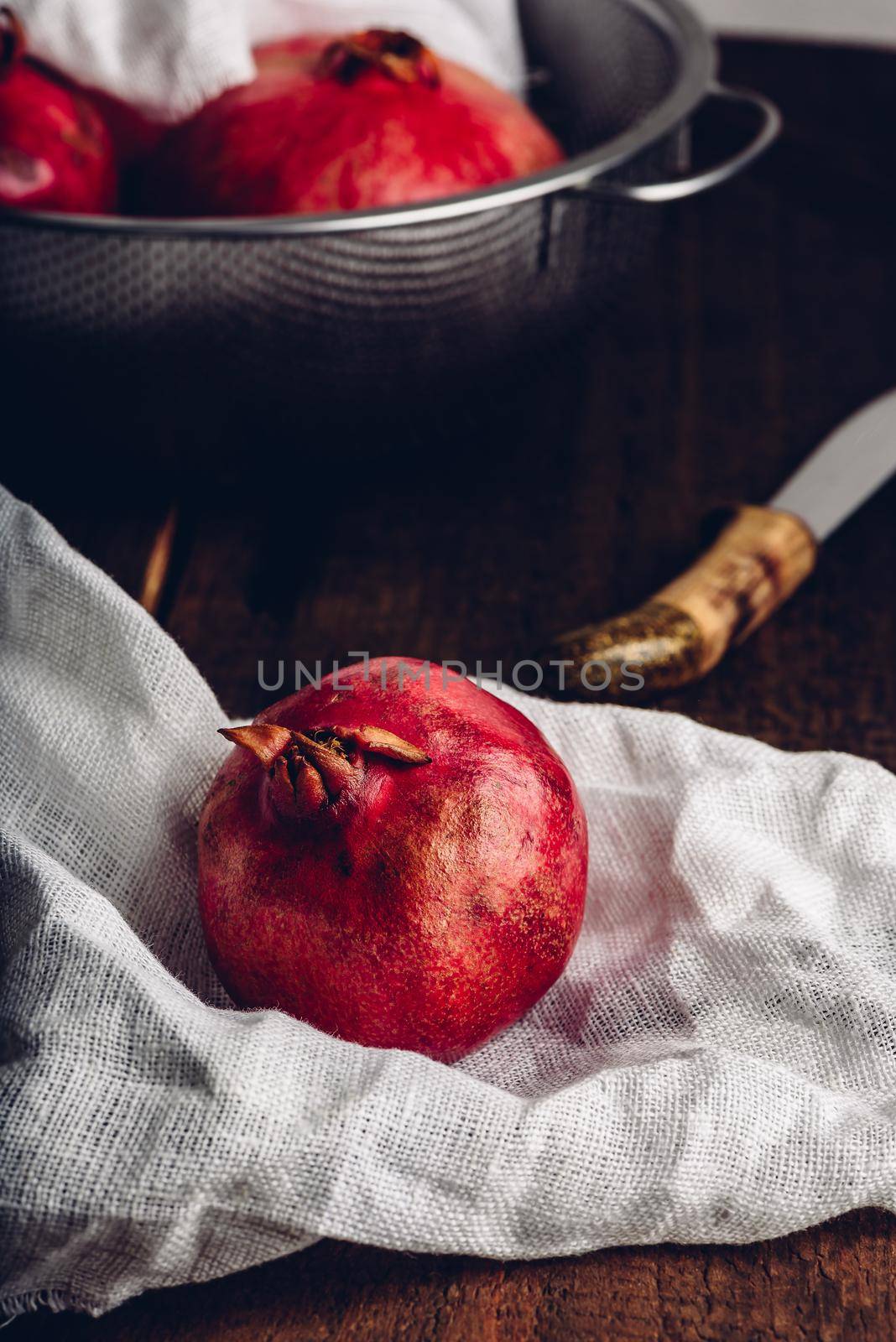 Red and ripe pomegranate fruits in rustic setting