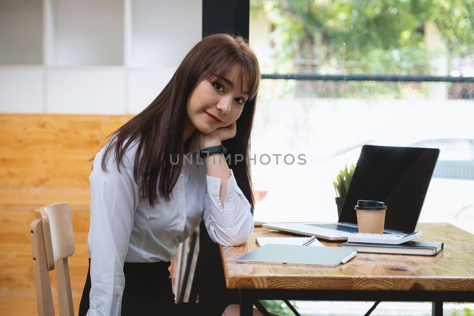 Cheerful young asian student female in living room. online learning, studying , online shopping, freelance, asean concept