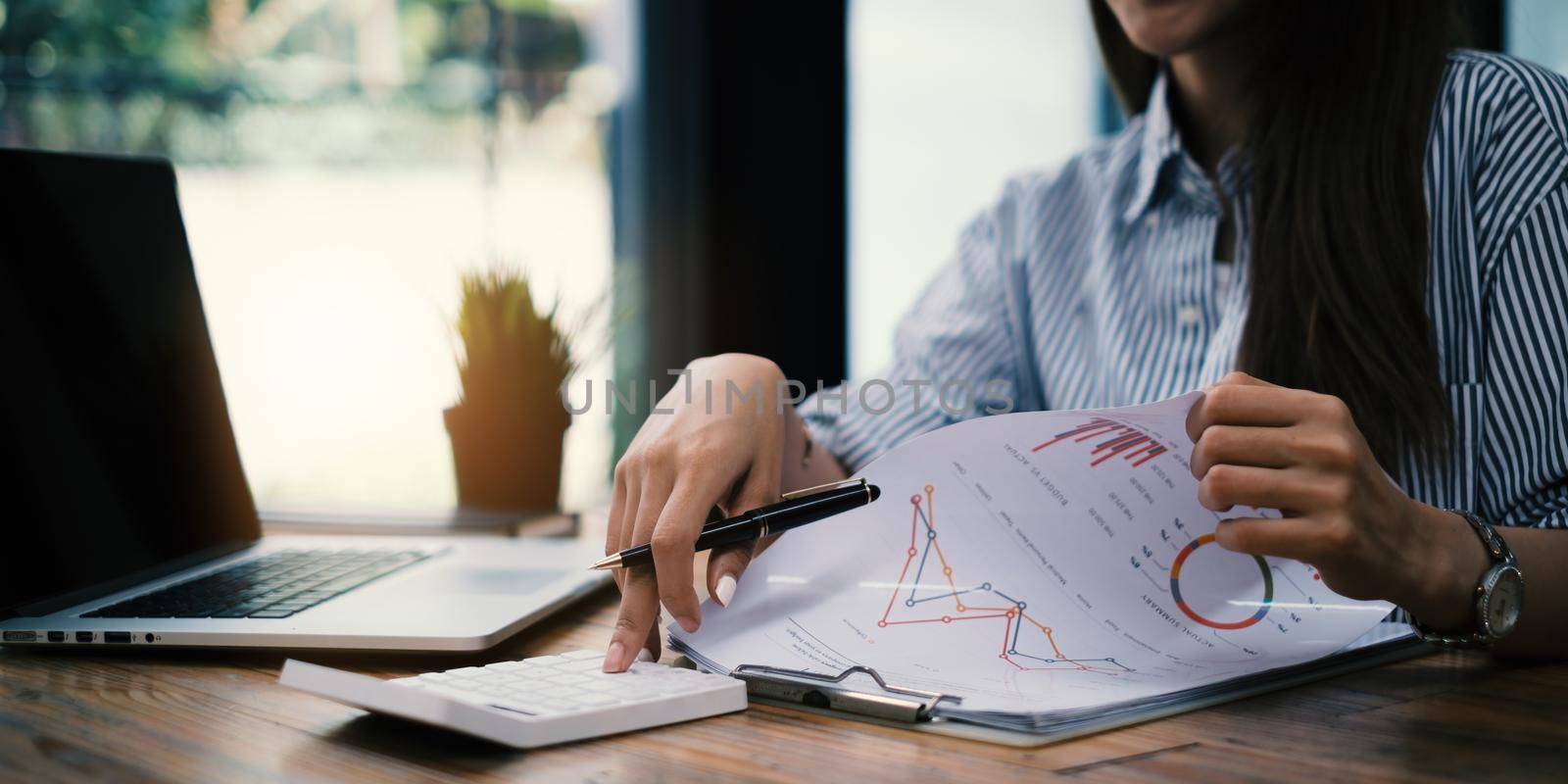 Fund managers researching and analysis Investment stock market by paperwork on wooden desk in office