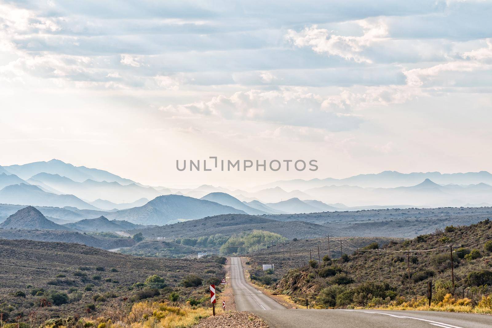 A hazy view from road R407 towards Klaarstroom. The Swartberg Mountains are visible