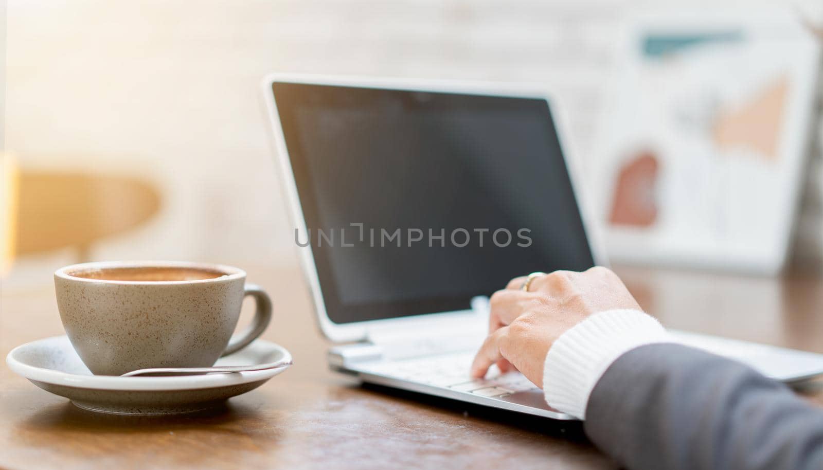 Hand using laptop for business online