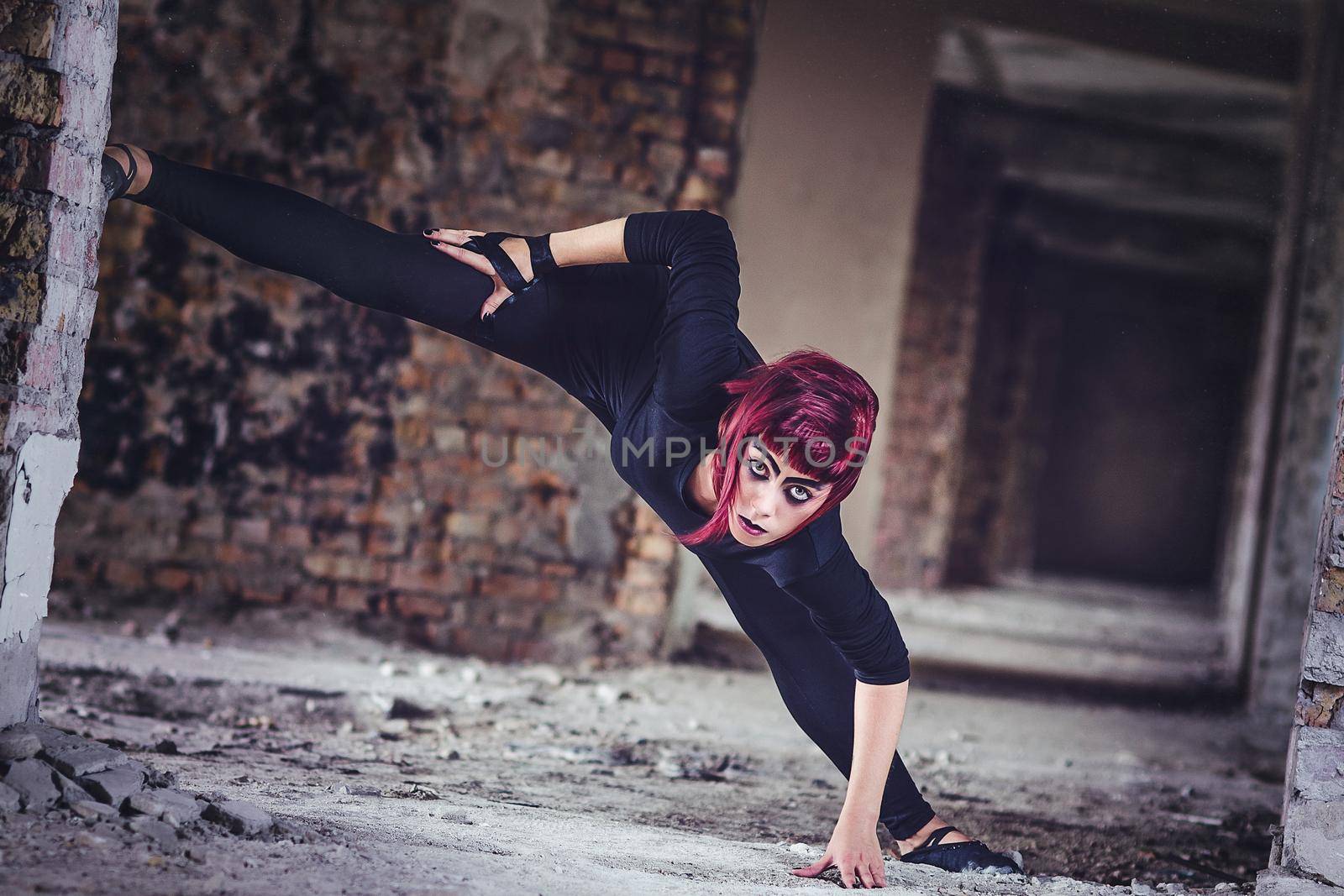 girl model in black with pink hair in an abandoned building