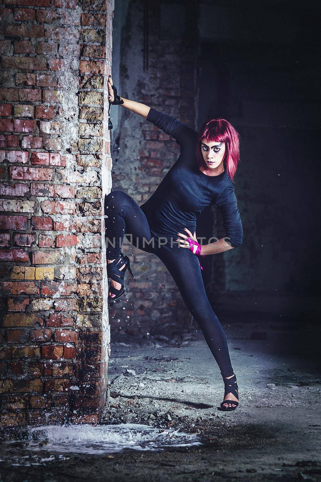 girl model in black with pink hair in an abandoned building