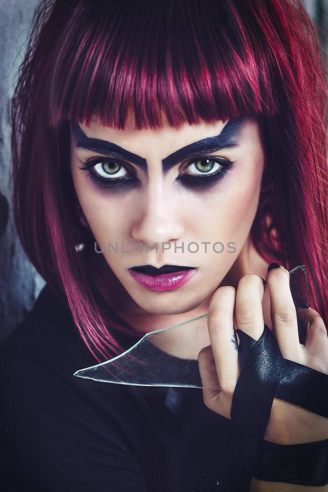 girl model in black with pink hair in an abandoned building