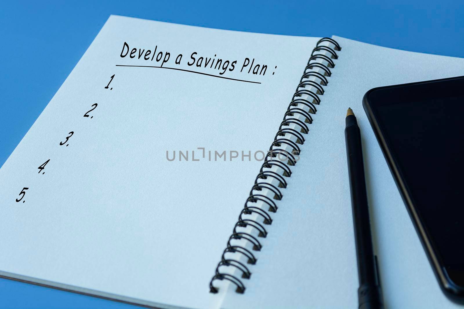 Develop a savings plan text on notepad with blue background