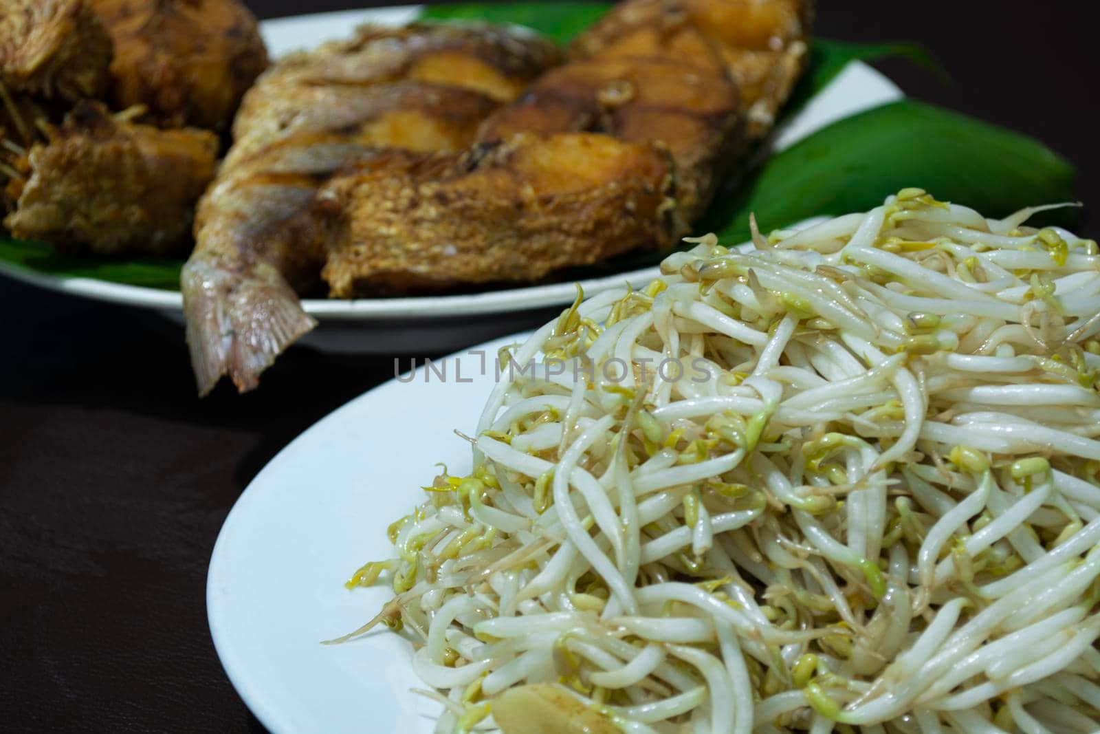 Fried bean sprouts with blurred background of fried fish
