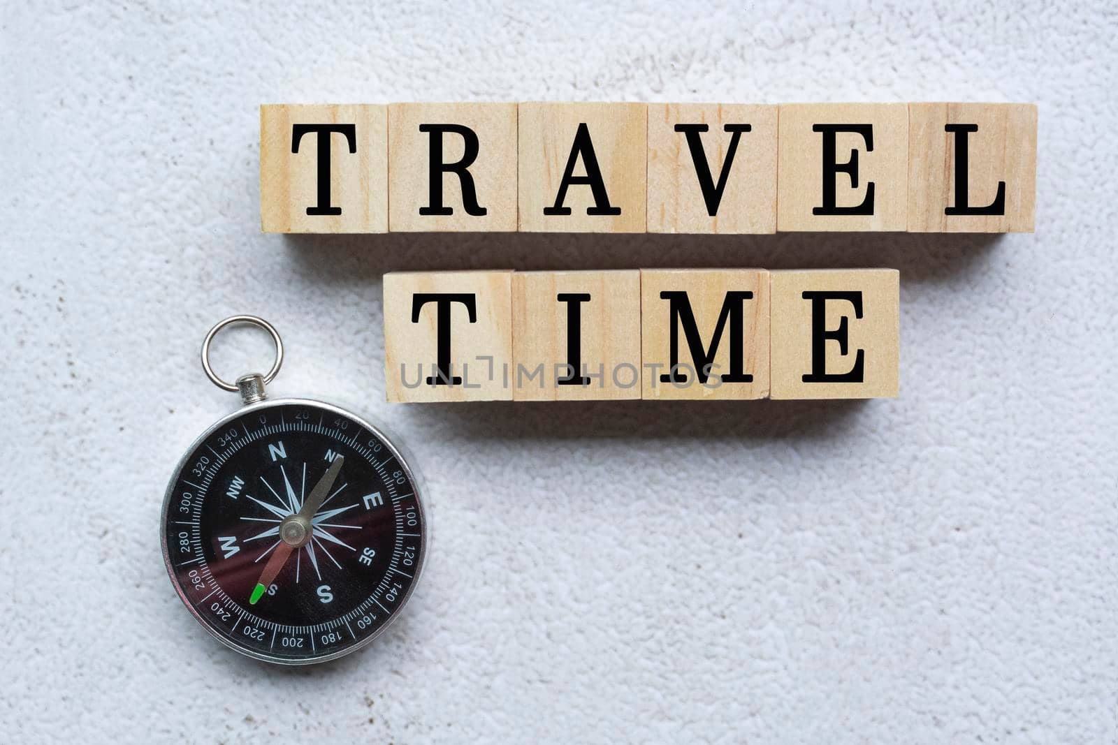 Travel time text on wooden cubes with compass direction on white background