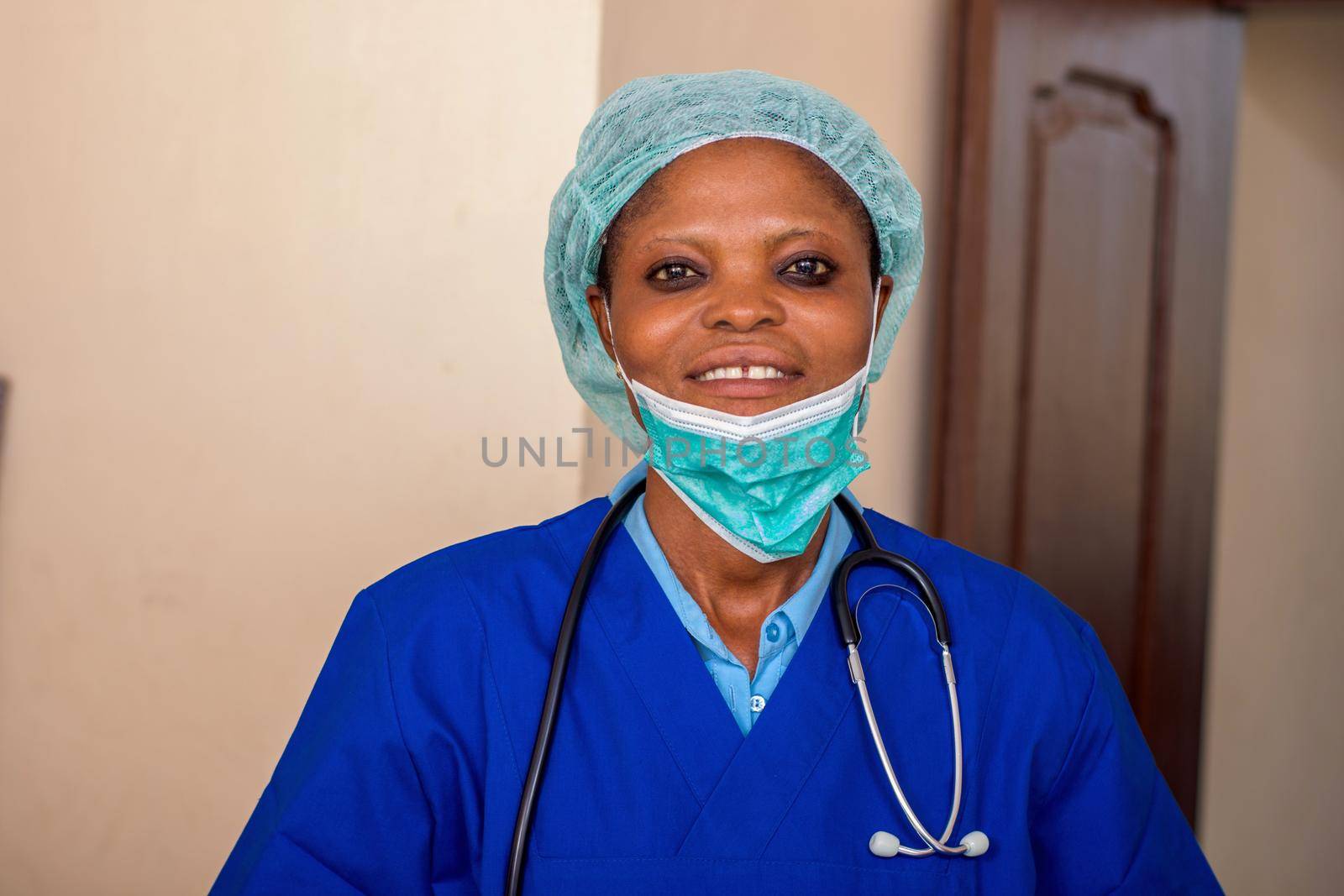 a young nurse standing with a stethoscope and a medical hat smiling at the camera.