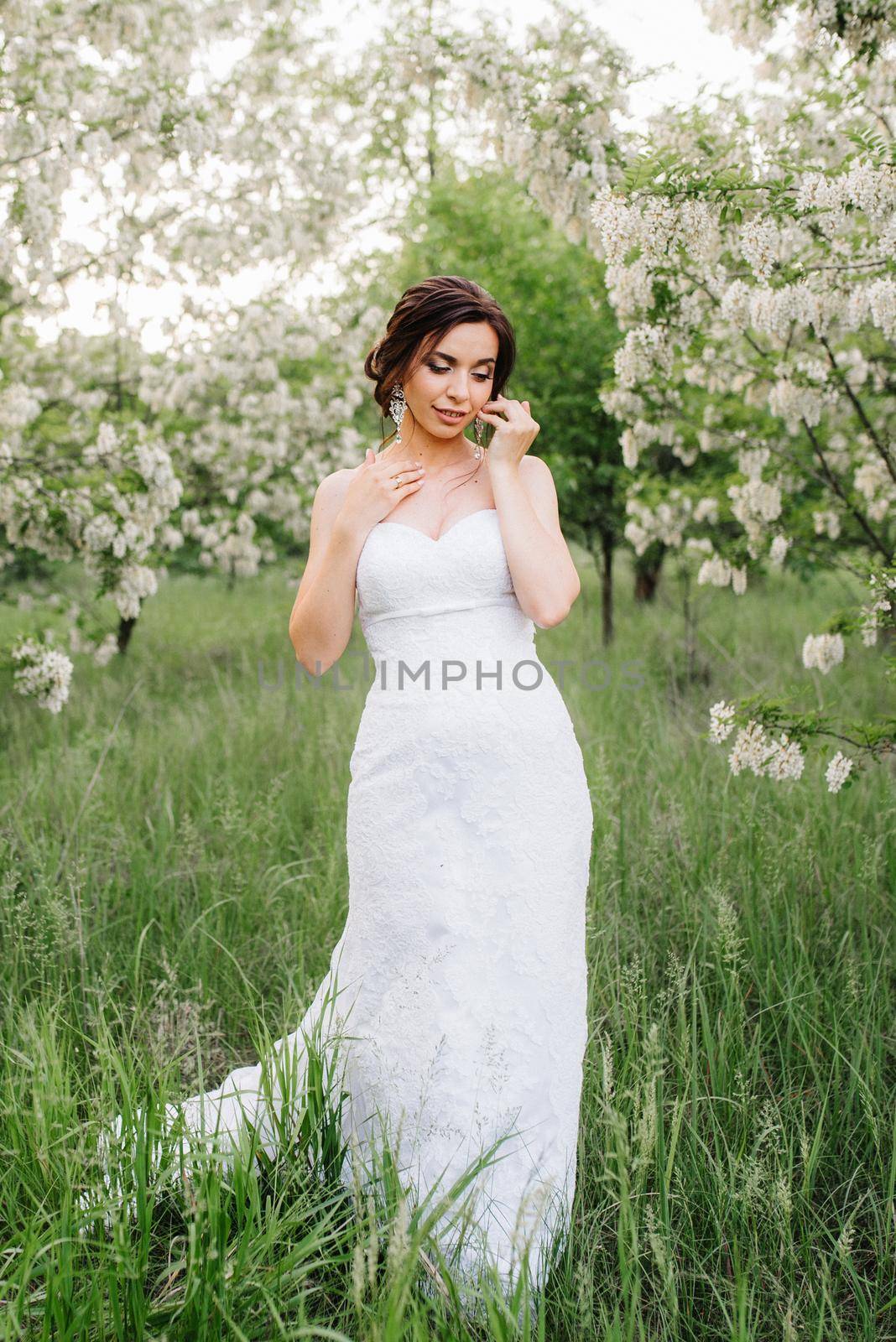 bride in a white dress with a large spring bouquet by Andreua