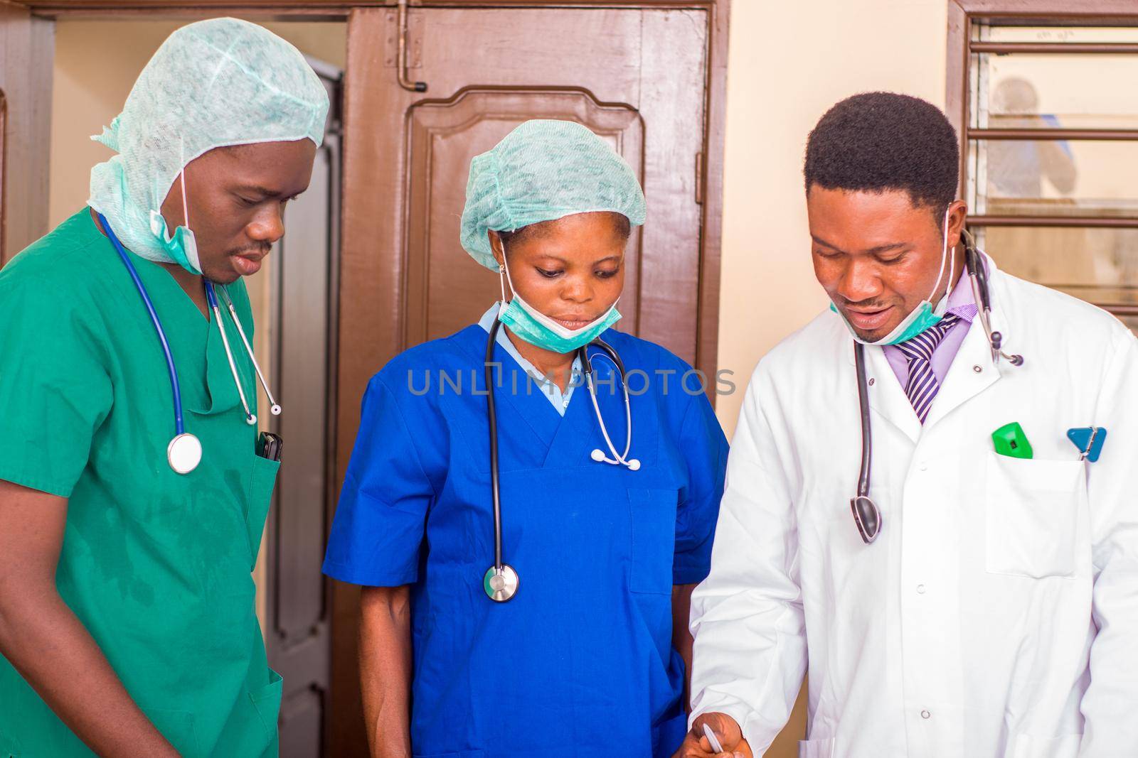 a team of young doctors standing in uniform and watching their program of work.