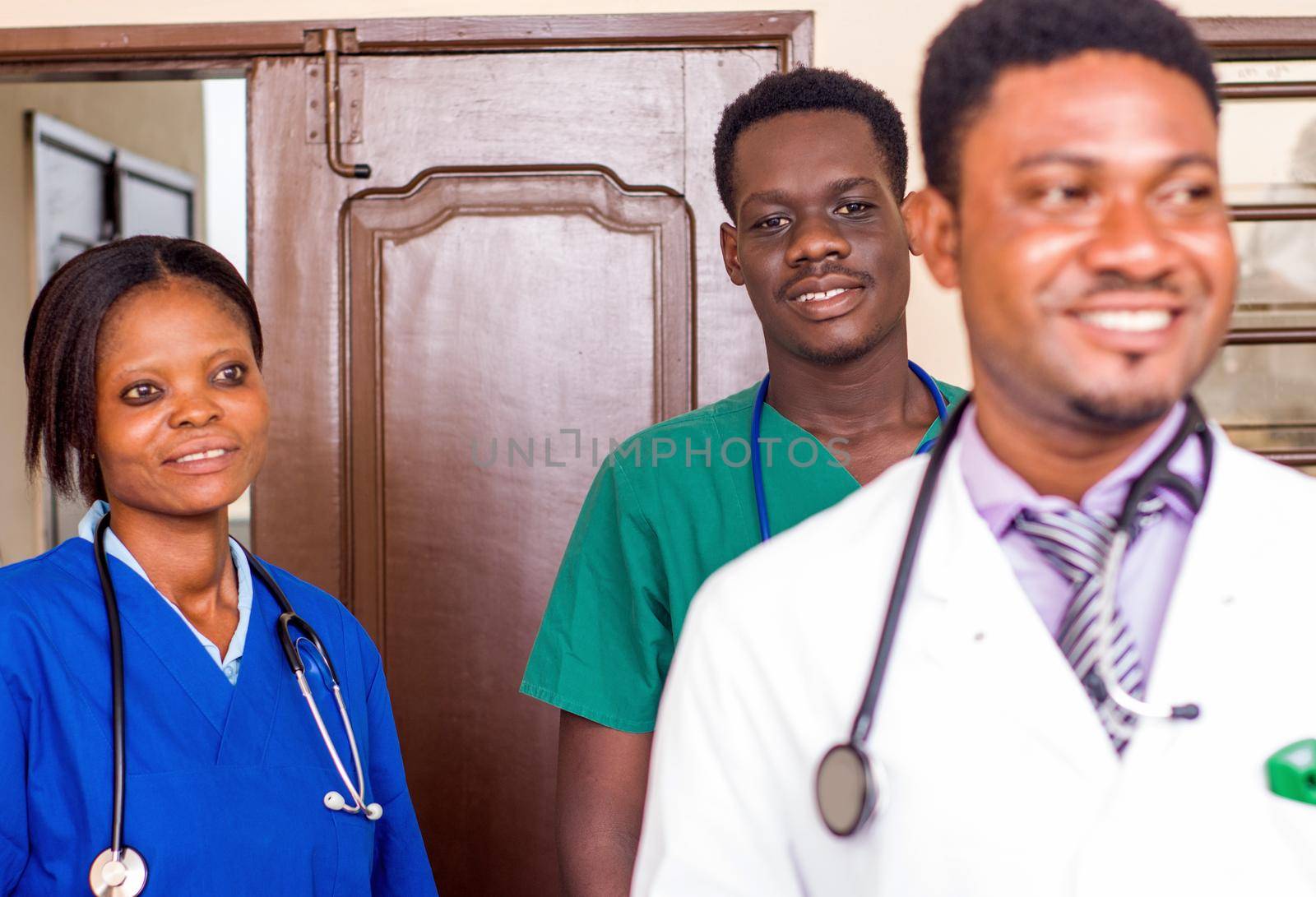 a team of doctors standing in a room ready for work.