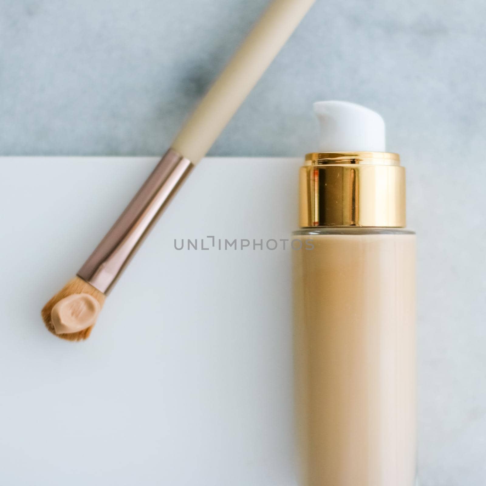 Makeup foundation bottle and contouring brush on marble, make-up concealer bb cream as cosmetics product for luxury beauty brand holiday design by Anneleven
