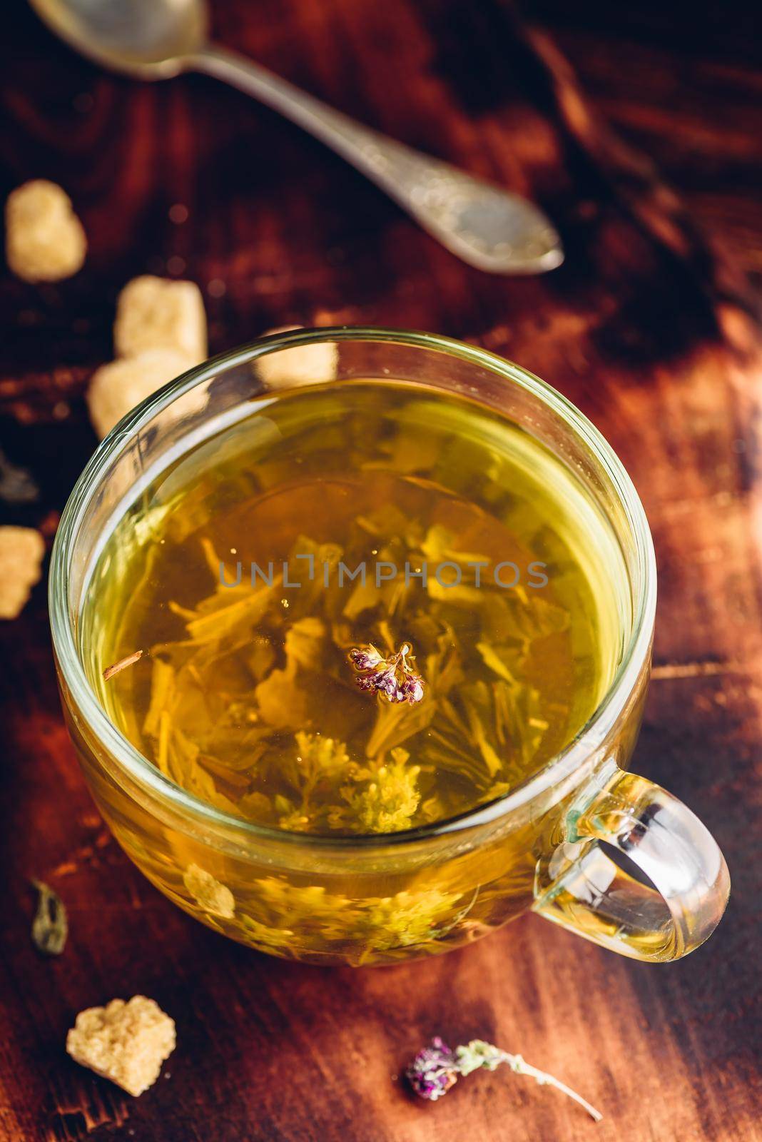 Cup of green tea with brown tea sugar by Seva_blsv