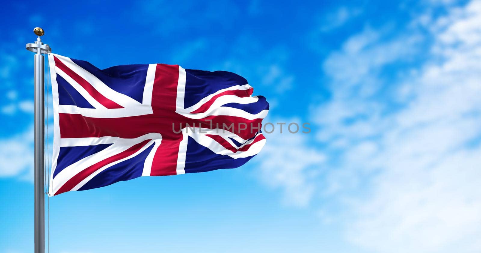 The national flag of the United Kingdom flying in the wind. Outdoors and sky in the background. by rarrarorro