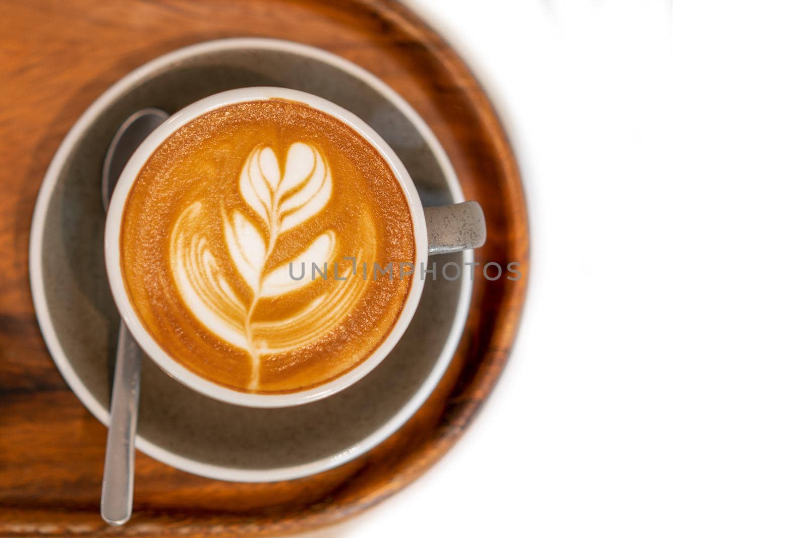 Hot coffee with beautiful latte art on isolated white
