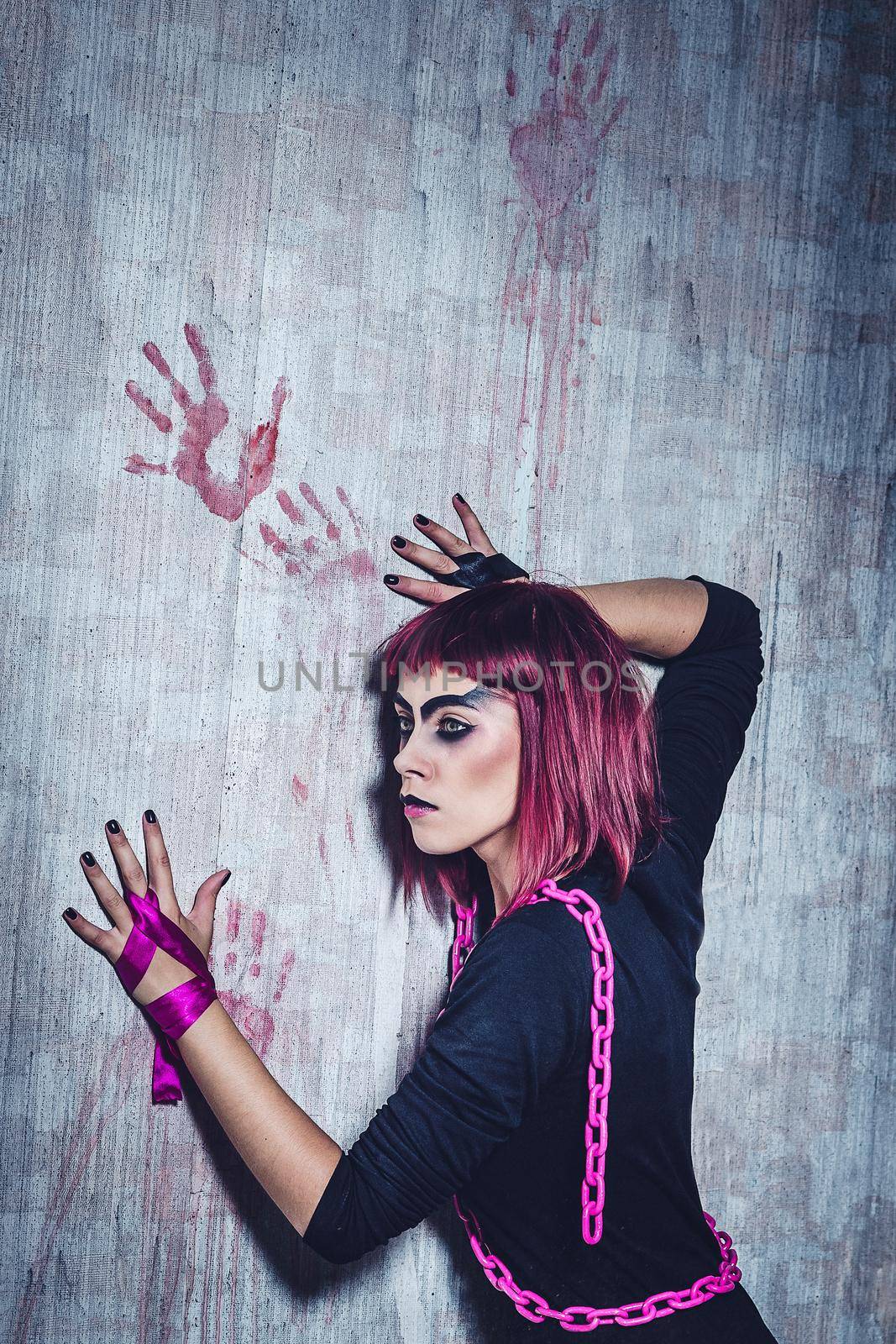 girl model in black with pink hair in an abandoned building