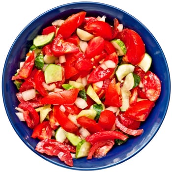 Salad from tomatoes, cucumbers and onions, in a dark blue salad dish, isolated on a white background, the top view.