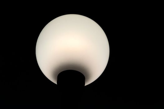 Spherical white lantern on the black background.