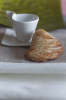 croissant and coffee cup at breakfast