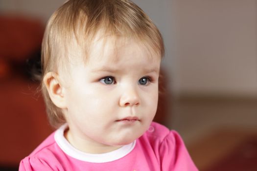 Baby girl watching tv at home