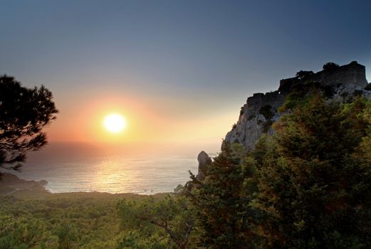 Sunset at Monolithos Venitian Castle on the west coast of Rhodes in Greece