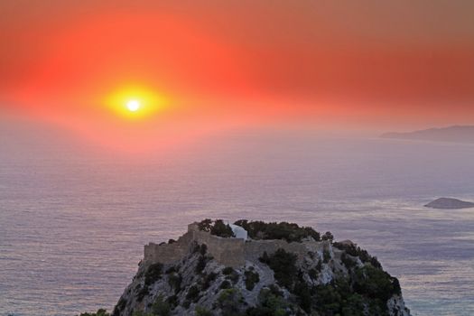 Sunset at Monolithos Venitian Castle on the west coast of Rhodes in Greece