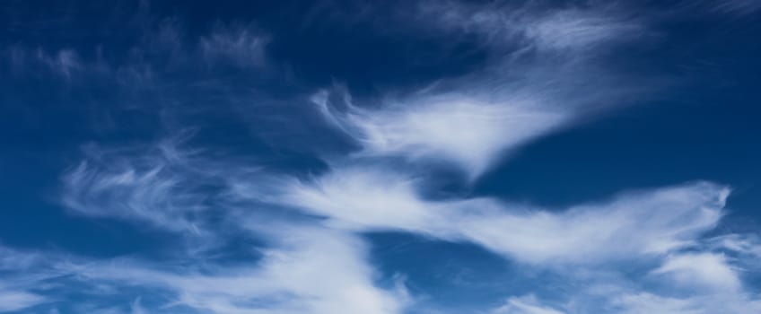 bright cumulus clouds and blue sky background banner