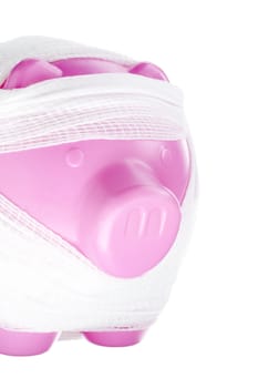 Close-up shot of bandaged piggy bank isolated on white background