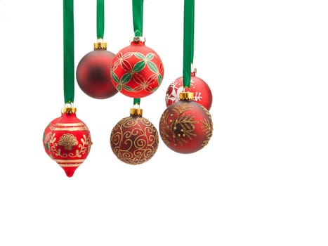 Christmas baubles hanging over white background.