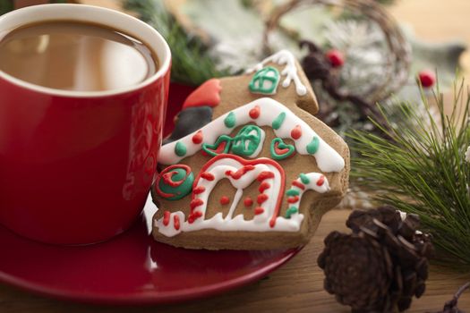 Gingerbread house and coffee on the saucer 