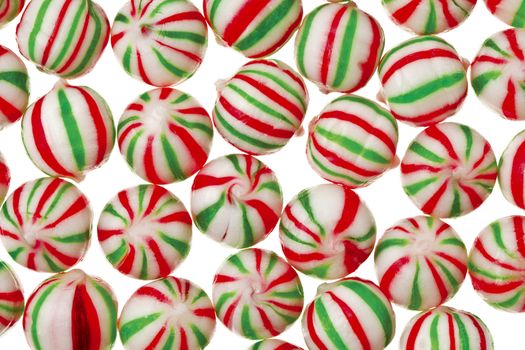 A delicious red and green peppermint candy on a white background 