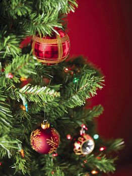 Image of red christmas bauble  with christmas lights