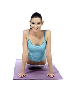 Portrait of beautiful lady practicing yoga exercise against white background