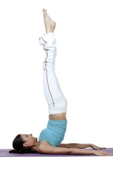 Young woman doing the shoulder stand in yoga exercise isolated in a white background 