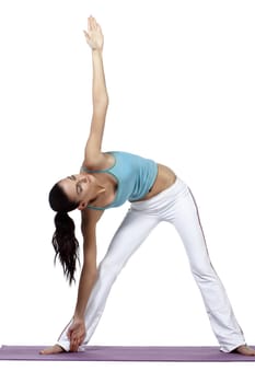 Young woman practicing yoga on mat