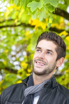 An image of a handsome young man in the autumn