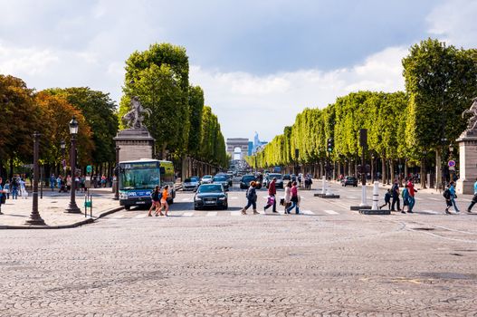 PARIS - AUGUST 14: Vehicles and tourists travel along Champs Elysees on August 14, 2010 - one of a famous touristic attractions in Paris.