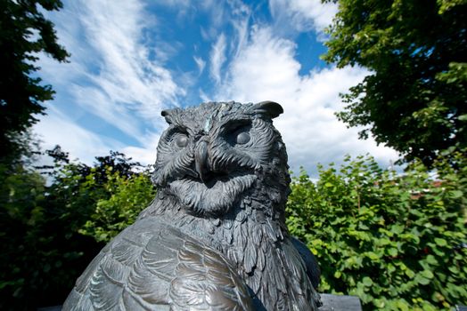 Statue of an Owl against a summer sky in Oslo botanical garden