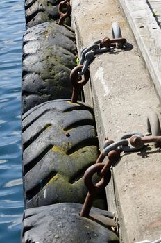 Tires chained to pier