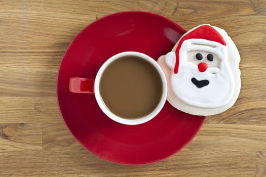 Santa Claus decoration and coffee on a red plate