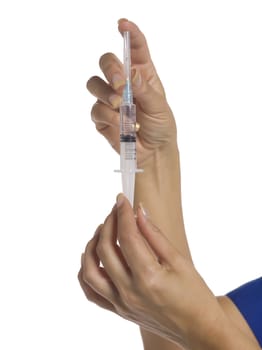 Close-up image of a doctor's hand holding medical syringe
