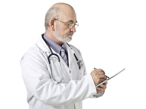 Horizontal image of a senior male doctor busy doing a paper work