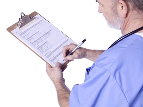 Side view image of a male doctor standing writing on the medical clipboard 