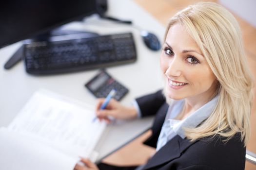 Beautiful businesswoman doing finances in the office