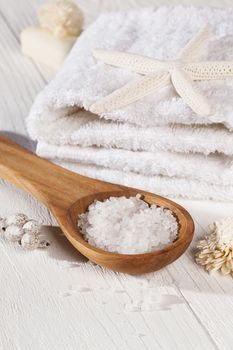 Towel and salt on a wooden spoon