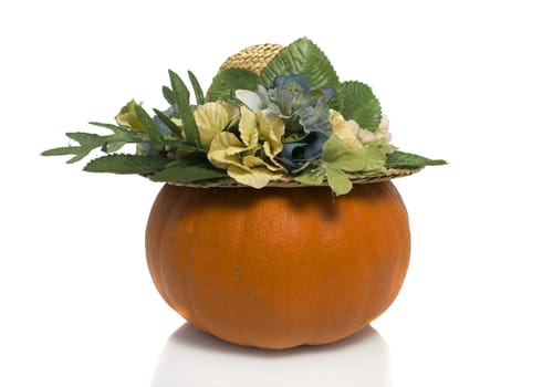 One big orange pumpkin with summer hat  over white background