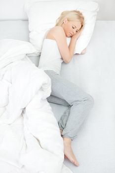 Young beautiful woman sleeping in bed at home