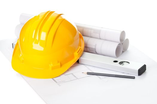 Image of  blueprints with level pencil and hard hat on table