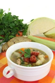 a cup of cabbage soup and fresh parsley